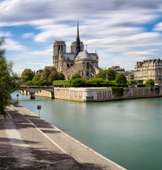 Long exposure of Notre Dame Cathedral & the Seine River on Ile de La Cite, Paris, France. The Cathedral exemplifies French Gothic architecture. 4th Arrondissement, 75004 Paris