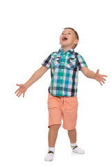Little boy in pink shorts and a summer shirt with short sleeves, gestures with hands and shouting with its mouth wide open - Isolated on white background