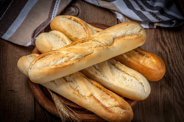 French baguettes on old wooden table.