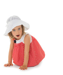 Lovely little girl in a white beach hat and polka dot dress - Isolated on white background