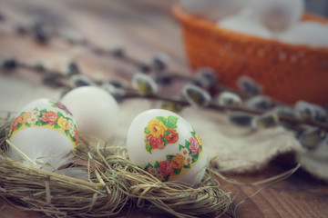 Decoupage Easter eggs in nest on rustic  background 