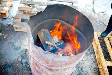 burning firewood in old barrel