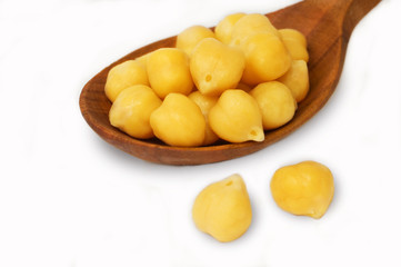 chickpeas over spoon on white background.