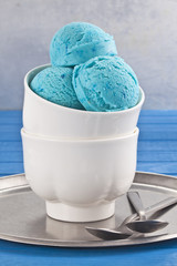 Blue ice cream cup on the blue table. - 104012152