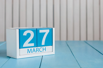 March 27th. Image of march 27 wooden color calendar on white background.  Spring day, empty space...