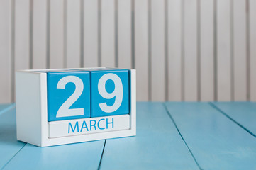March 29th. Cube calendar for march 29 on wooden surface with empty space For text
