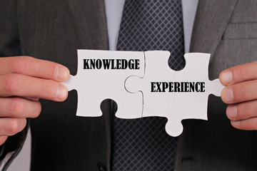 Business success concept. Connection between Knowledge and Experience, Businessman holding two...