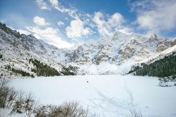 Sunny winter day in Polish Tatra mountains, frozen Morskie Oko lake