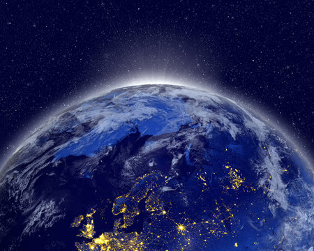 Planet earth with appearing sunlight. Visible city lights. Elements of this image furnished by NASA.