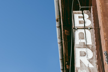 Bar sign on old wooden house