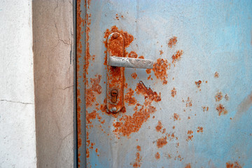 Old rusty door handle on emergency exit.