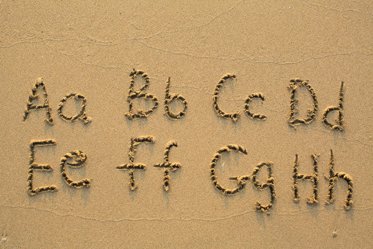 Alphabet written in light beach sand, part 1 of 4 (A-H)