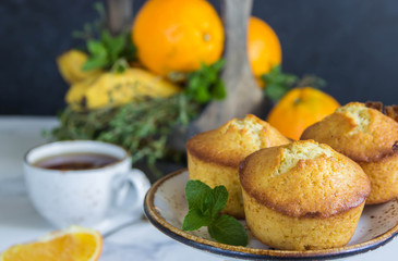 Fruit muffins  from oranges, mint and wooden box with fruits,cup tea