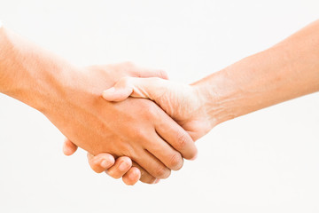 Shaking hands of two male people, isolated on white.