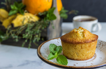 Fruit muffin  from oranges, mint and wooden box with fruits,cup tea.