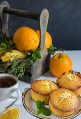 Fruit muffins  from oranges, mint and wooden box with fruits,cup tea.