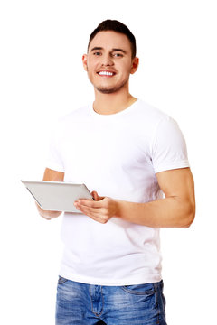Young handsome man using tablet
