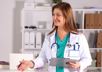 File folders, standing on  shelves in the background