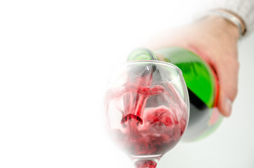 pouring wine in a glass,soft focus
