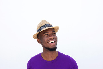 Young man with hat looking away and smiling