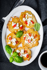 Potato pancakes with goat's curd, chili peppers and basil