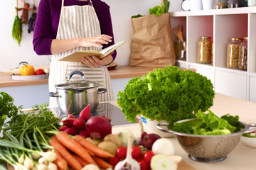 Young Woman Cooking in the kitchen. Healthy Food