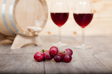 Still life with red wine and wooden cask.