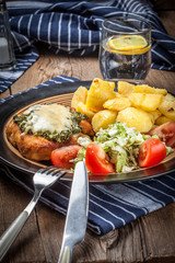 Fried chicken fillet with spinach and cheese.