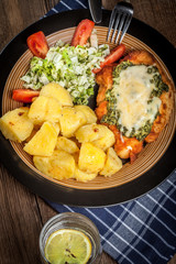 Fried chicken fillet with spinach and cheese.