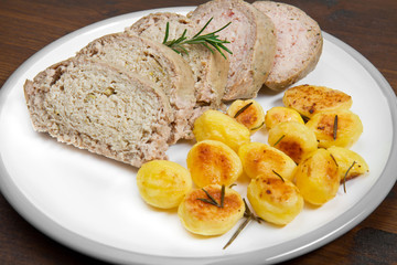Meat loaf with roasted potatoes on dish