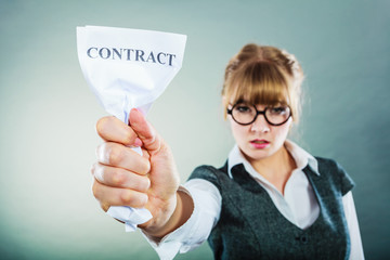 unhappy business woman showing crumpled contract