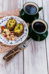 Stuffed potatoes covered with cheddar cheese
