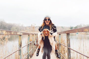 Outdoor lifestyle portrait of two best friends, smiling and having fun together, enjoy each other...