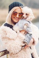 young caucasian cute girl portrait with dog outdoor in park walking happy and smile all the way
