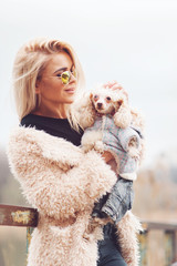 young caucasian cute girl portrait with dog outdoor in park walking happy and smile all the way

