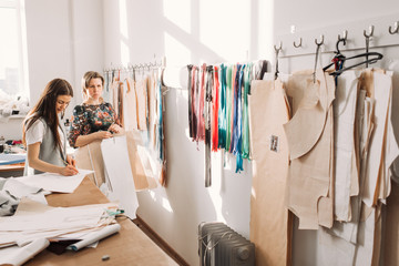 the work of fashion designer and tailors in the shop - Powered by Adobe