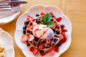 Waffle with ice cream,grape,strawberry and strawberry sauce