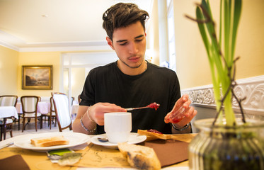Attractive Young Man Eating Breakfast