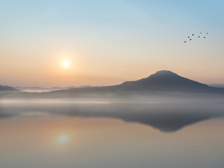 beautiful sunrise and mountain with Water Reflection.
