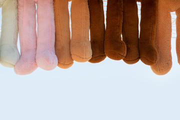 Colorful teddy bears lined legs relaxed.