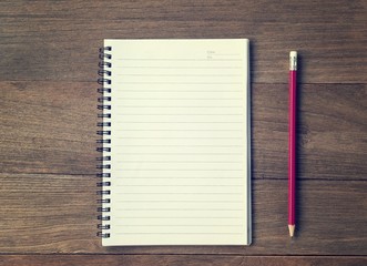 Blank Small notepad  and  pencil on the wooden table. View from