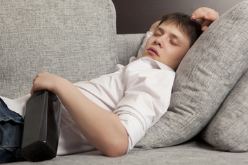 A man with a drinking problem is relaxing on a sofa