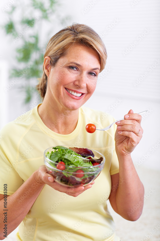 Wall mural Elderly woman eating salad.