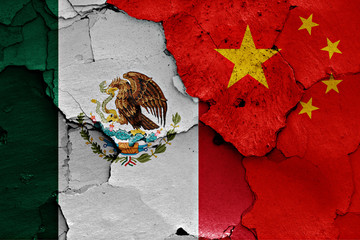 flags of Mexico and China painted on cracked wall