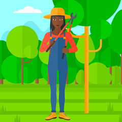 Farmer with pruner in garden.