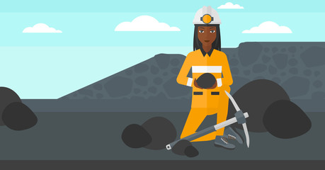 Miner holding coal in hands.