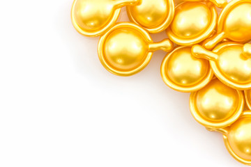 Fototapeta na wymiar Hair vitamin serum capsule gold color.