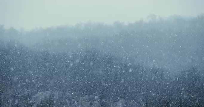 Heavy winter snow storm - dramatic weather cold climate nature background. 4K video footage cinematic.