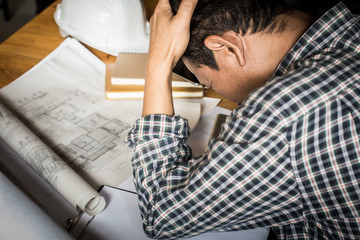 Businessman serious examining blueprints with dark retro style