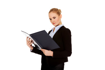 Thoughtful focused businesswoman reading her notes